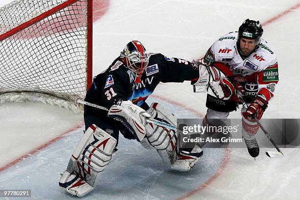 Goalkeeper Fred Brathwaite of Mannheim makes a save against Jason Jaspers of Koeln during the DEL match between Adler Mannheim and Koelner Haie at...