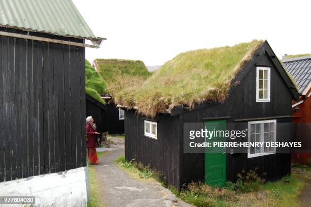 Picture taken on June 4, 2018 shows old houses with vegetal roofs in the old city of Torshavn, on the Streymoy Island, the largest of Faroe Islands...