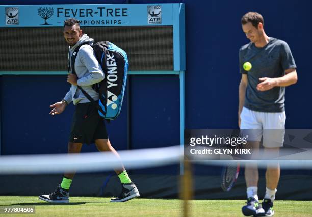 Australia's Nick Kyrgios has a word with Britain's Andy Murray as he practices, ahead of their first round match at the ATP Queen's Club...