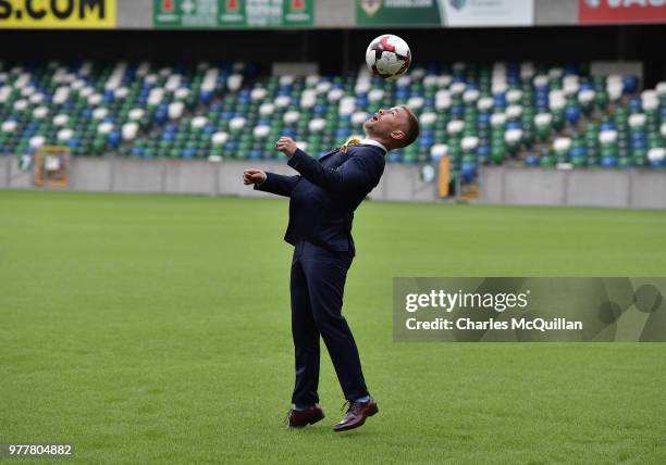 Boxer Carl Frampton plays keep up with a football as he attends a photo call at Windsor Park on June 18, 2018 in Belfast, Northern Ireland. The three...