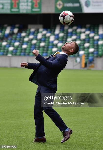 Boxer Carl Frampton plays keep up with a football as he attends a photo call at Windsor Park on June 18, 2018 in Belfast, Northern Ireland. The three...