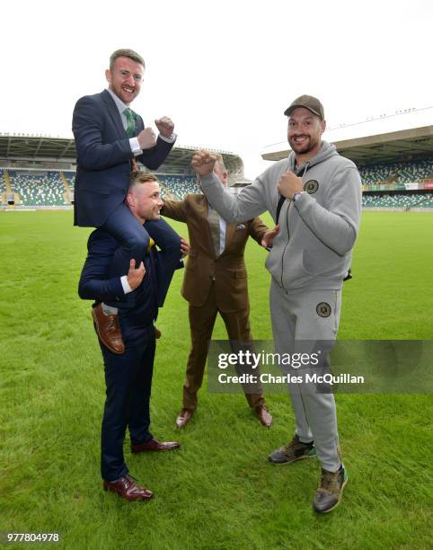 Boxer Carl Frampton gives friend and fellow boxer Paddy Barnes a leg up as he goes toe to toe with Tyson Fury watched by promoter Frank Warren as...