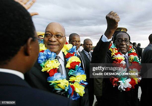 South African President Jacob Zuma and Zimbabwean counterpart Robert Mugabe are seen at Harare International Airport on March 16, 2010. President...