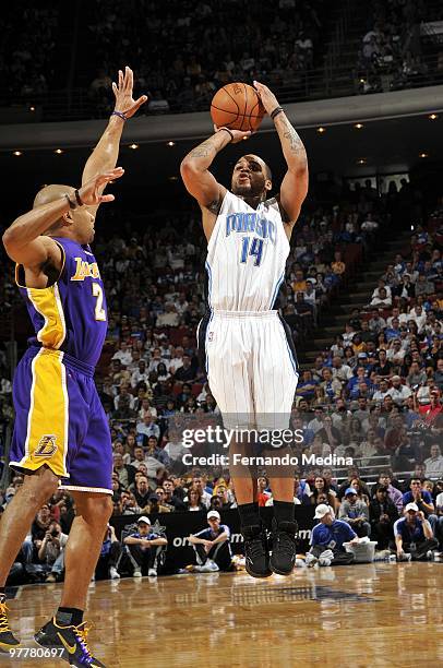 Jameer Nelson of the Los Angeles Lakers shoots a jump shot against Derek Fisher of the Orlando Magic during the game at Amway Arena on March 7, 2010...