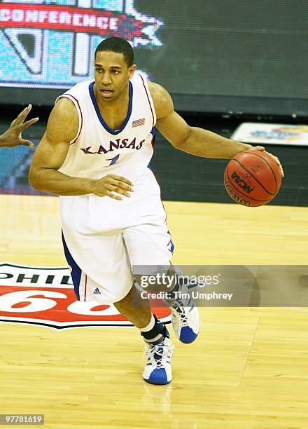 Xavier Henry of the Kansas Jayhawks dribbles around the defense of the Kansas State Wildcats in the 2010 Phillips 66 Big 12 Men's Basketball...