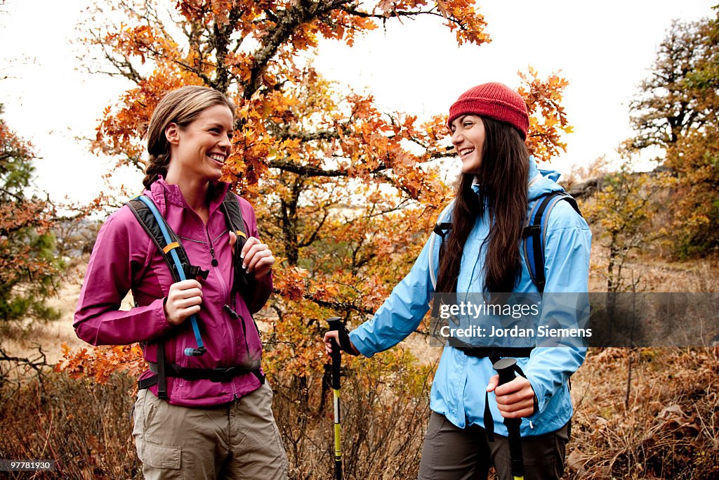Two young women laughing together while out hiking in the Columbia River Gorge, Oregon.
