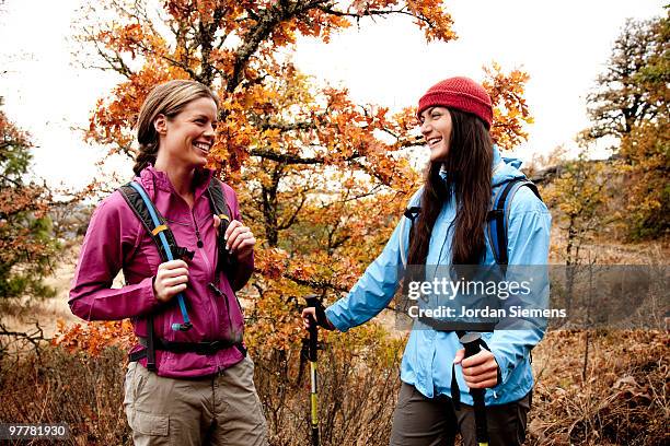 two young women laughing together while out hiking in the columbia river gorge, oregon. - newfriendship stock pictures, royalty-free photos & images