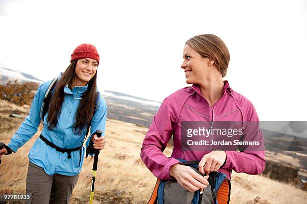 two females smile while day hiking in the columbia gorge, oregon. - newfriendship stock pictures, royalty-free photos & images