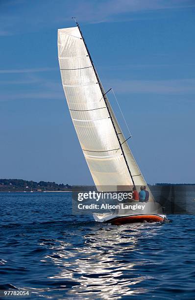 three adults enjoying a sunny day on board a daysailer on casco bay, maine. - casco stockfoto's en -beelden