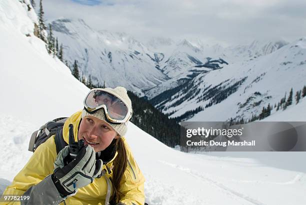 a young woman radios from the backcountry.  canadian rockies. - glenn marshal stock pictures, royalty-free photos & images