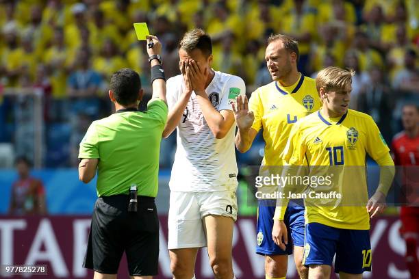 Referee Joel Aguilar of Salvador gives a yellow card to Kim Shin-wook of South Korea during the 2018 FIFA World Cup Russia group F match between...