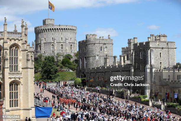 Guards of the Blues and Royals regiment and the military band march around the crowds waiting for Royal family and The Knights of the Garter to...