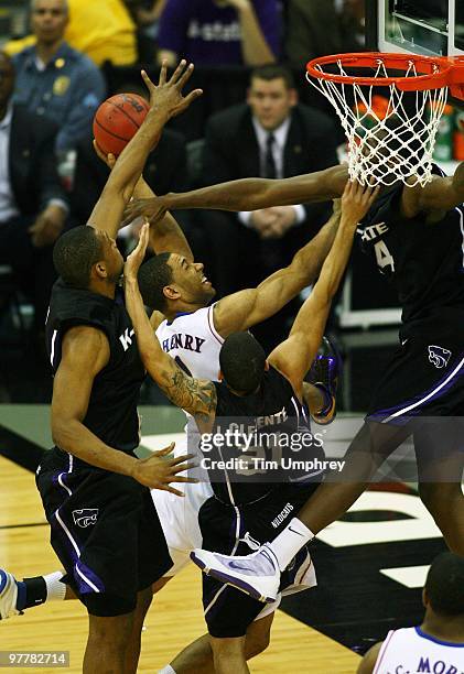 Xavier Henry of the Kansas Jayhawks goes up for a shot while defended by multiple Kansas State Wildcats in the 2010 Phillips 66 Big 12 Men's...