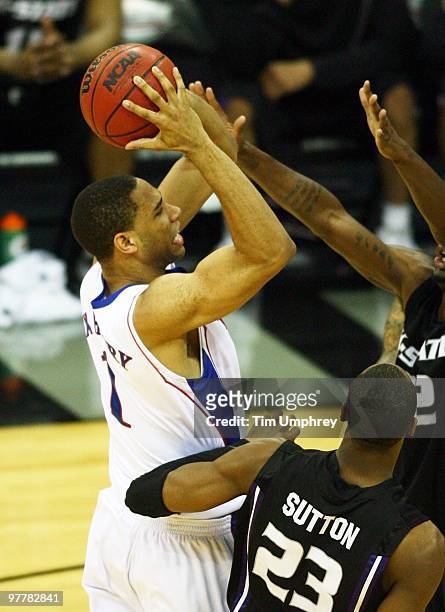 Xavier Henry of the Kansas Jayhawks shoots while being defended by Dominque Sutton of the Kansas State Wildcats in the 2010 Phillips 66 Big 12 Men's...