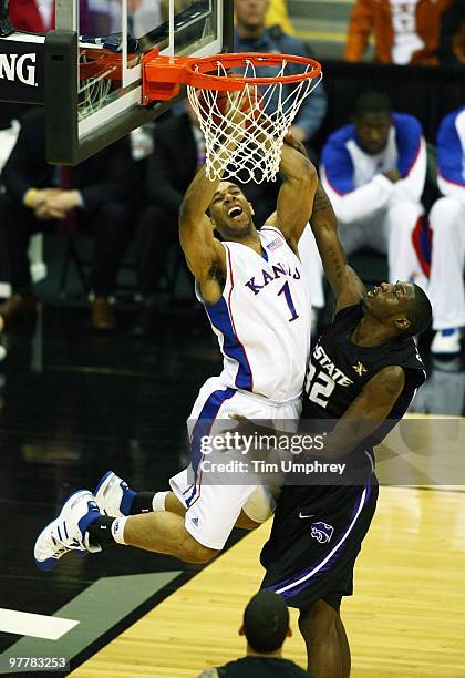 Xavier Henry of the Kansas Jayhawks is fouled as he attacks the rim by Jamar Samuels of the Kansas State Wildcats during the 2010 Phillips 66 Big 12...