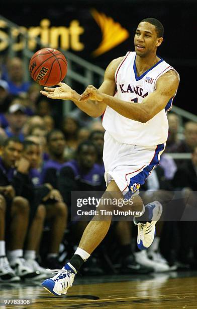 Xavier Henry of the Kansas Jayhawks passes the ball off against the Kansas State Wildcats during the 2010 Phillips 66 Big 12 Men's Basketball...