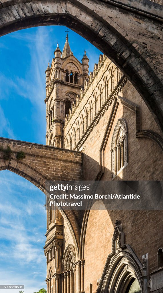 The arches of the Palazzo Arcivescovile with the medieval bell tower of the Cathedral