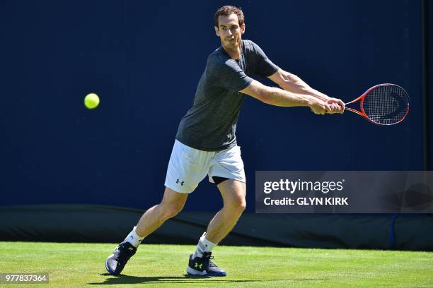 Britain's Andy Murray prepares to play a double-handed backhand during practice, ahead of his first round match at the ATP Queen's Club Championships...