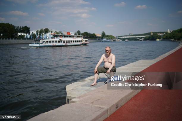 Man sunbathes on the banks of the Moscow River on June 18, 2018 in Moscow, Russia.