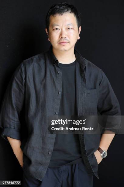 Designer Yosuke Aizawa poses backstage ahead of the Hunting World show during Milan Men's Fashion Week Spring/Summer 2019 on June 18, 2018 in Milan,...