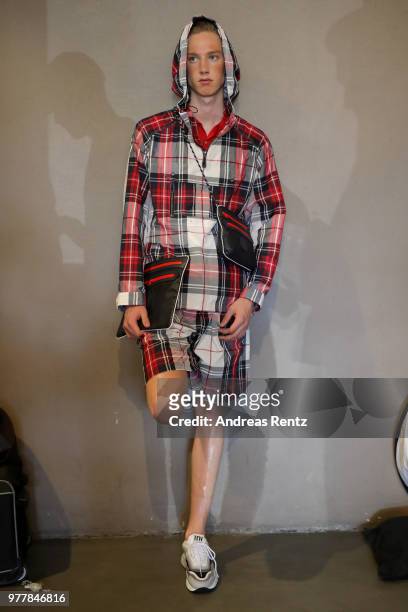 Model is seen backstage ahead of the Hunting World show during Milan Men's Fashion Week Spring/Summer 2019 on June 18, 2018 in Milan, Italy.