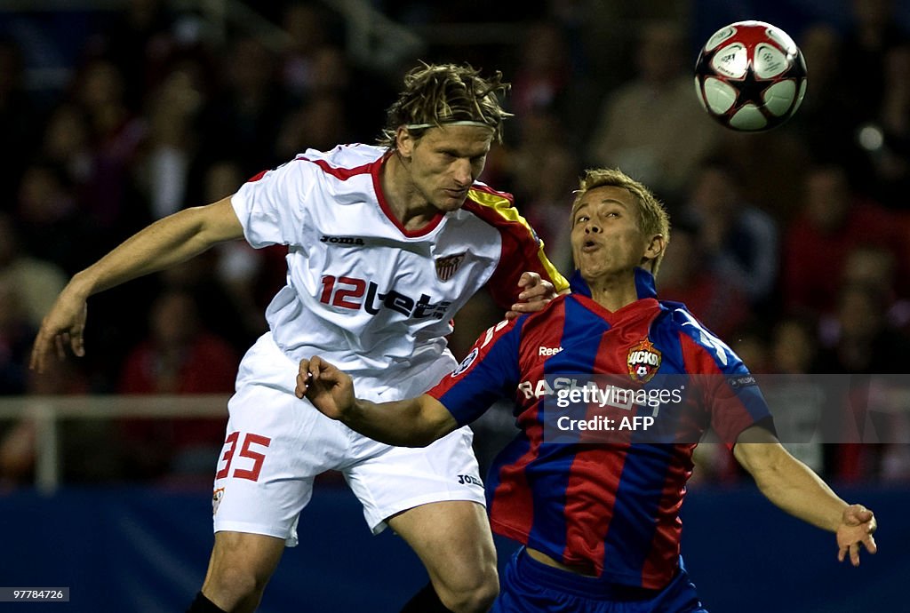 Sevilla's Marius Stankevicius (L) vies w