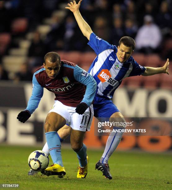 Aston Villa's English forward Gabriel Agbonlahor vies with Wigan Athletic's Scottish defender Gary Caldwell during the English Premier league...