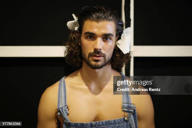 Model is seen backstage ahead of the Hunting World show during Milan Men's Fashion Week Spring/Summer 2019 on June 18, 2018 in Milan, Italy.