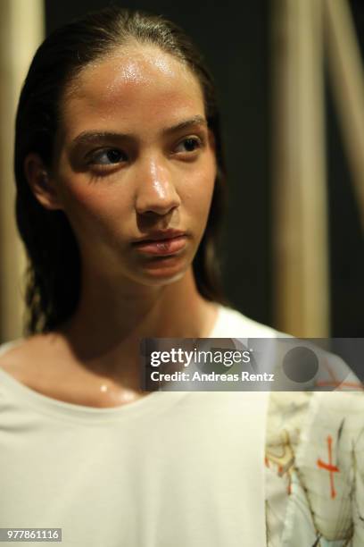 Model is seen backstage ahead of the Hunting World show during Milan Men's Fashion Week Spring/Summer 2019 on June 18, 2018 in Milan, Italy.