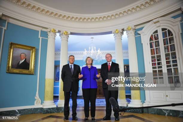 Secretary of State Hillary Clinton speaks as Northern Ireland First Minister Peter Robinson and Deputy First Minister Martin McGuiness look on ahead...