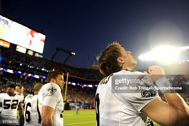 Drew Brees of the New Orleans Saints gestures to the sky during the National Anthem before a game against the Indianapolis Colts in Super Bowl XLIV...