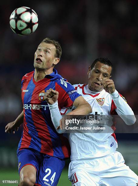 Vasili Berezutski of CSKA Moscow duels for a high ball with Luis Fabiano of Sevilla during the UEFA Champions League round of sixteen second leg...