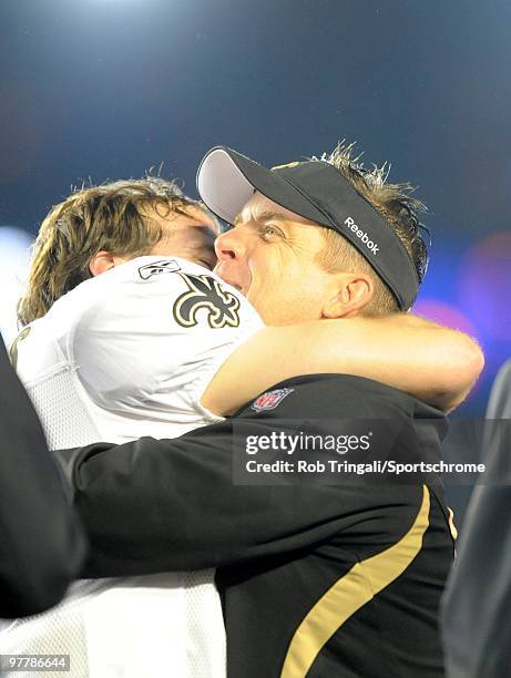 Head coach Sean Payton of the New Orleans Saints celebrates with Drew Brees on the podium after defeating the Indianapolis Colts in Super Bowl XLIV...