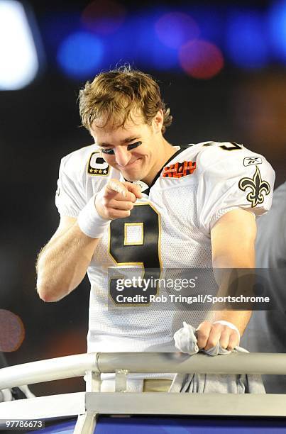 Drew Brees of the New Orleans Saints gestures to his teammates from the podium after a game against the Indianapolis Colts in Super Bowl XLIV on...