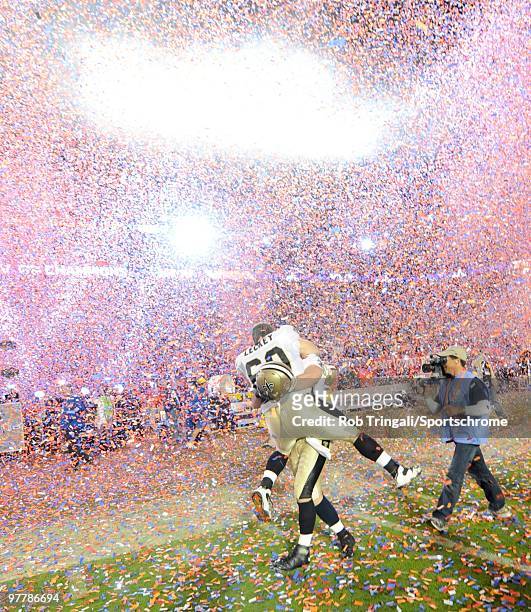 Nick Leckey of the New Orleans Saints celebrates on the field with a teammate after defeating the Indianapolis Colts in Super Bowl XLIV on February...
