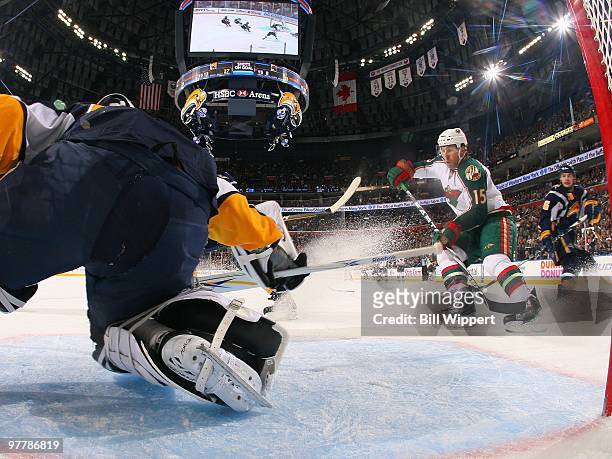 Andrew Brunette of the Minnesota Wild looks for a rebound in front of Ryan Miller of the Buffalo Sabres on March 12, 2010 at HSBC Arena in Buffalo,...