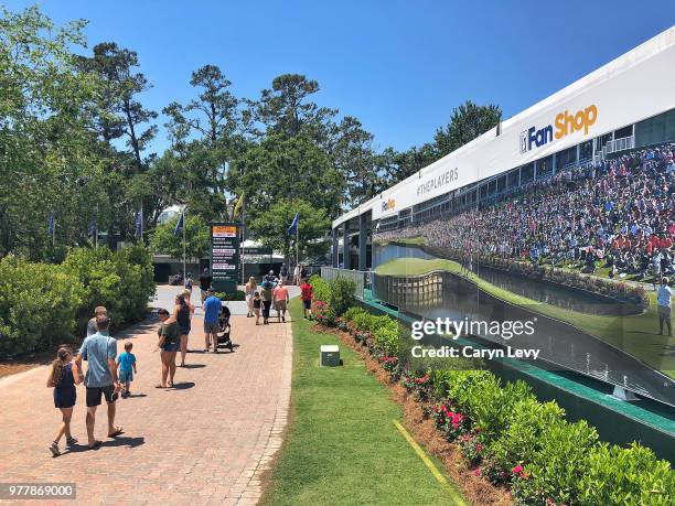 Fans walk by the Fan Shop merchandise tent during practice for THE PLAYERS Championship on THE PLAYERS Stadium Course at TPC Sawgrass on May 8, 2018...