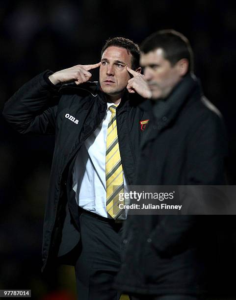 Malky Mackay manager of Watford gives a signal as Roy Keane manager of Ipswich looks on during the Coca-Cola Championship match between Watford and...