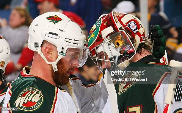 Greg Zanon of the Minnesota Wild congratulates goaltender Josh Harding after their victory against the Buffalo Sabres on March 12, 2010 at HSBC Arena...
