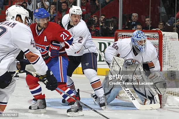 Brian Gionta of Montreal Canadiens waits for a pass in front of Aaron Johnson of the Edmonton Oilers and goalie Devan Dubnyk during the NHL game on...