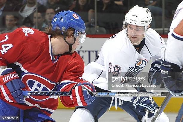 Sergei Kostitsyn of Montreal Canadiens battles for the puck with Sam Gagner of Edmonton Oilers during the NHL game on March 11, 2009 at the Bell...