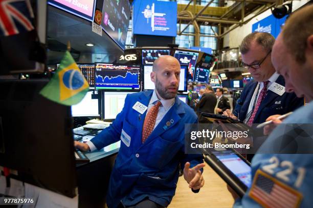 Traders work on the floor of the New York Stock Exchange in New York, U.S., on Monday, June 18, 2018. U.S. Stocks shook off the worst of their losses...