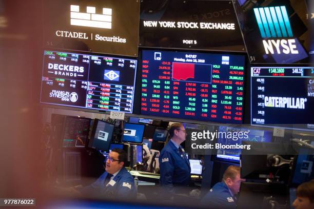 Traders work on the floor of the New York Stock Exchange in New York, U.S., on Monday, June 18, 2018. U.S. Stocks shook off the worst of their losses...