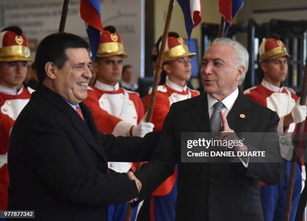 Paraguay's President Horacio Cartes welcomes Brazil's President Michel Temer upon his arrival for the Mercosur Summit in Luque, Paraguay, on June 18,...