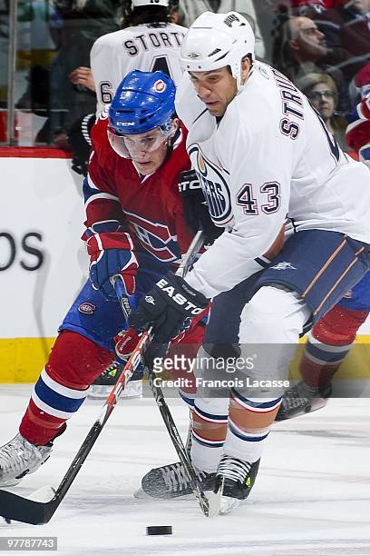 Ben Maxwell of the Montreal Canadiens battles for the puck with Jason Strudwick of Edmonton Oilers during the NHL game on March 11, 2009 at the Bell...