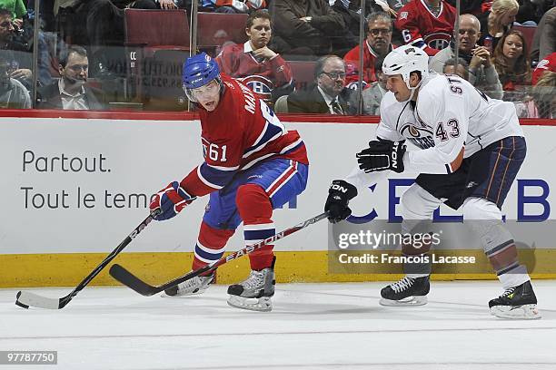 Ben Maxwell of the Montreal Canadiens makes a pass in front of Jason Strudwick of Edmonton Oilers during the NHL game on March 11, 2009 at the Bell...