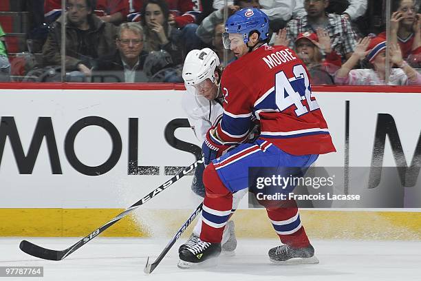 Dominic Moore of the Montreal Canadiens battles for the puck with Tom Gilbert of Edmonton Oilersduring the NHL game on March 11, 2009 at the Bell...