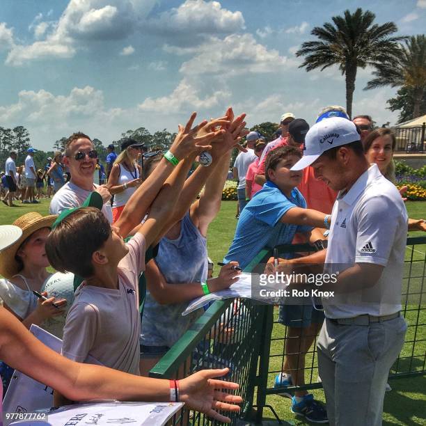 Xander Schauffele signs autographs during the first round of THE PLAYERS Championship on THE PLAYERS Stadium Course at TPC Sawgrass on May 11, 2018...
