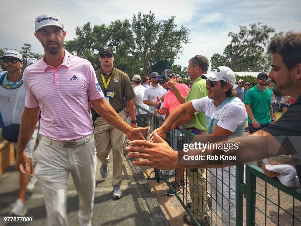 Dustin Johnson high fives fans during the third round of THE PLAYERS Championship on THE PLAYERS Stadium Course at TPC Sawgrass on May 12, 2018 in...