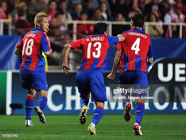 Keisuke Honda of CSKA Moscow celebrates with team mates after scoring his side's second goal during the UEFA Champions League round of sixteen second...